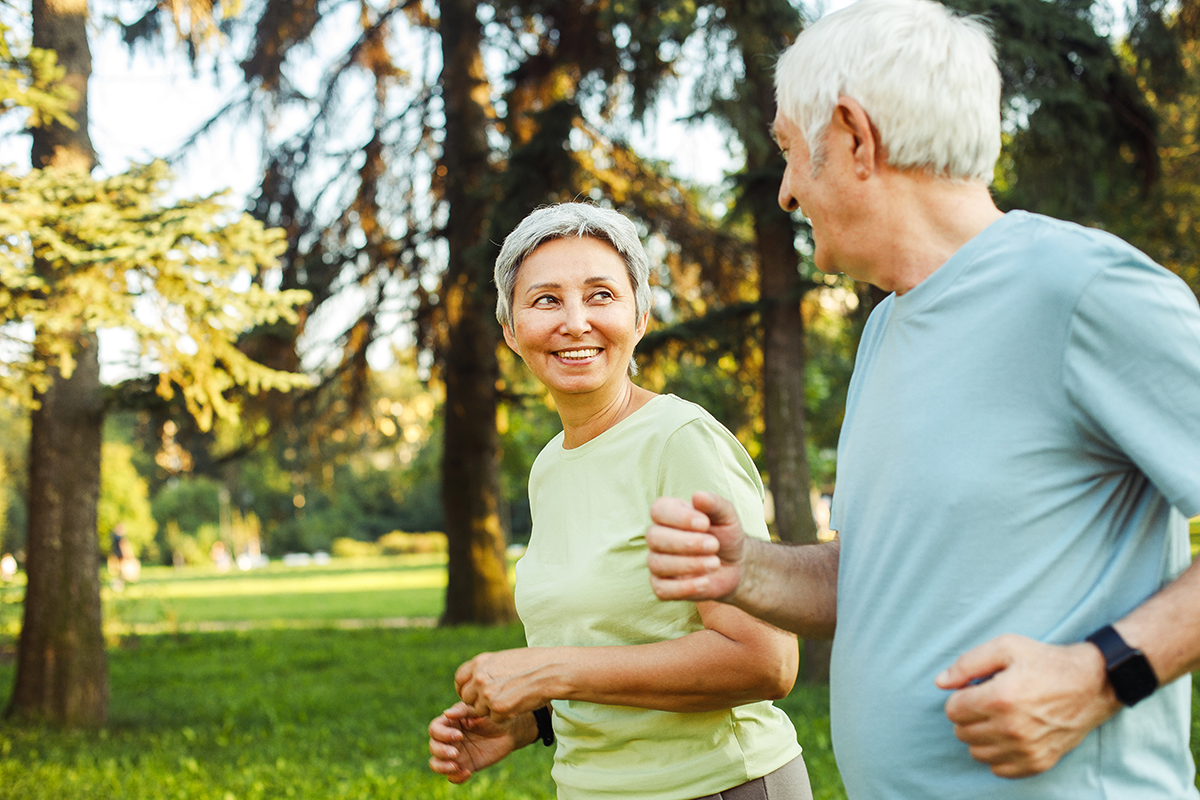Smiling senior couple jogging in the park